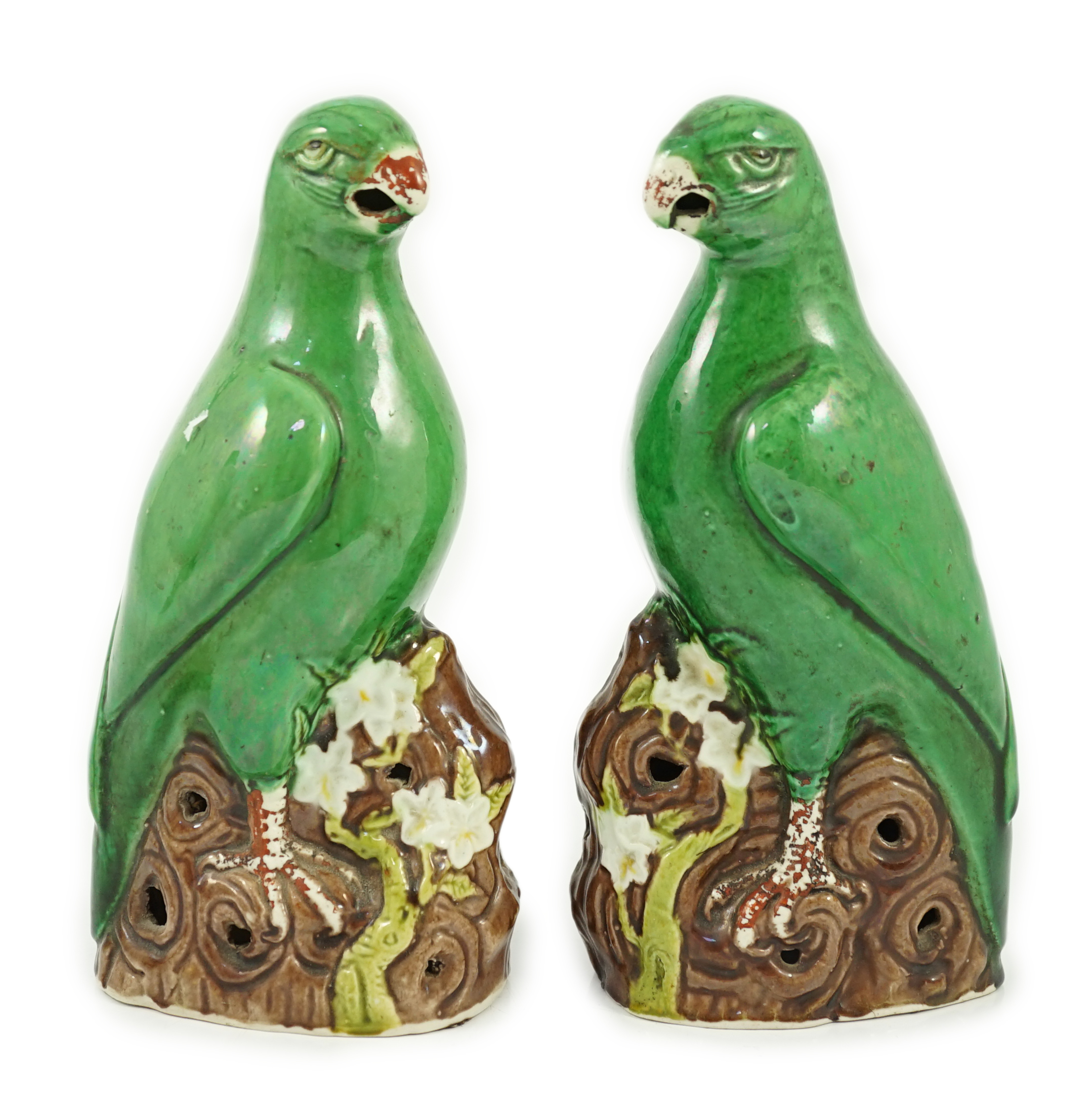 A pair of Chinese green glazed models of parrots, Kangxi period, hairline cracks to one tail feather